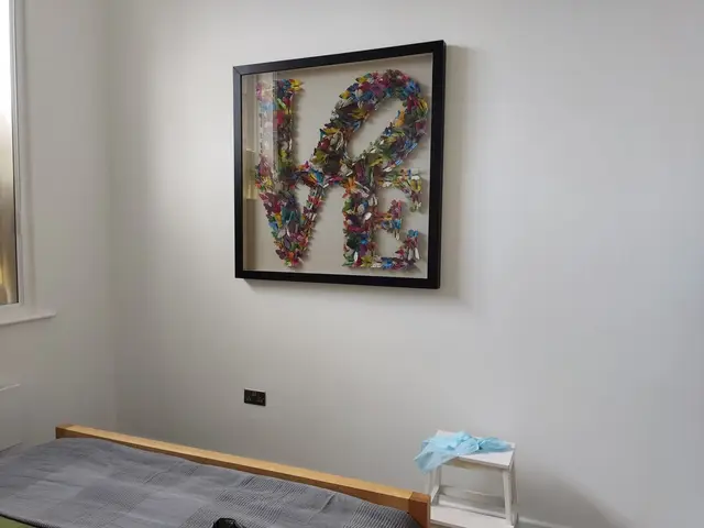 Large framed artwork mounted on a bedroom wall