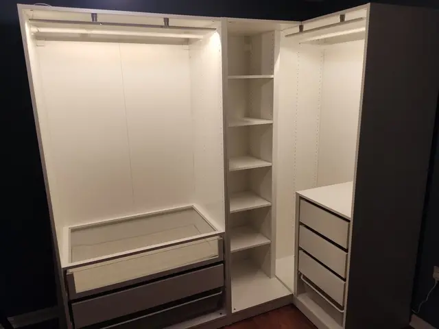 Inside of an assembled IKEA PAX wardrobe with drawers