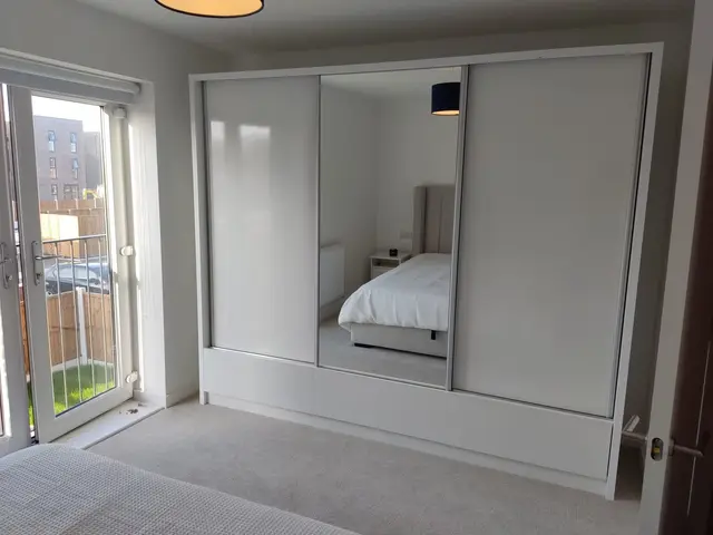 White sliding wardrobe with mirror door